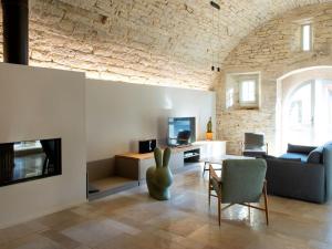 a living room with a couch and a table and a tv at Gîte de charme rénové avec cheminée à Fondremand - FR-1-583-422 in Fondremand +27 photos