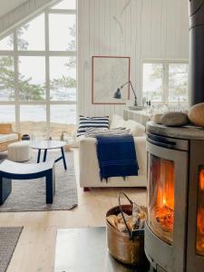 a living room with a fireplace and a couch at Bayfront Bliss Embracing Storholmens Allure in Lidingö