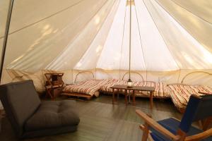 a room with a tent with a table and a chair at 南阿蘇 StayHappy in Minami Aso