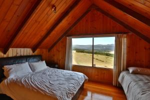 מיטה או מיטות בחדר ב-Cloudy Bay Villa