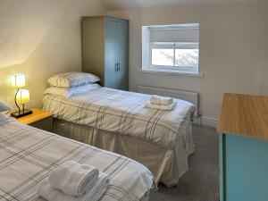 ein Zimmer mit zwei Betten und einem Fenster in der Unterkunft Granary Cottage - Uk10994 in Eshott + 2 Fotos