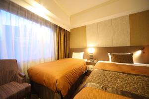 Un ou plusieurs lits dans un hébergement de l'établissement Hotel Metropolitan Nagano