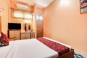 a bedroom with a large bed and a television at Hotel Gangotri Pvt Ltd in Bharatpur +2 photos