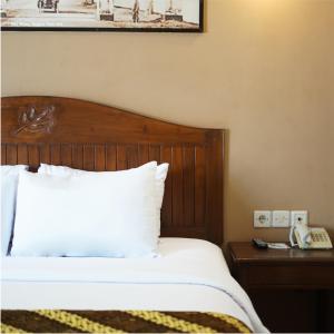 Postel nebo postele na pokoji v ubytování Bukit Daun Hotel & Resort