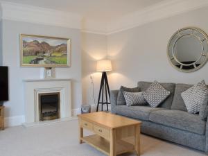 a living room with a couch and a fireplace at The Birches in Keswick