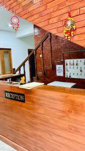 a reception area of a building with a wooden floor at Lotus Lake View Inn in Bhīm Tāl