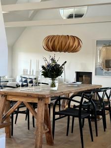 a dining room with a wooden table and chairs at Aesthetic Rural Idyll In East Funen in Nyborg