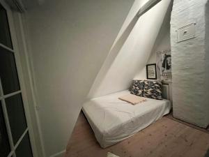 a small room with a bed in the attic at Aesthetic Rural Idyll In East Funen in Nyborg