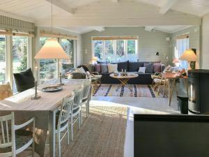 a living room with a table and a couch at Summerhouse By Tisvilde Hegn Forest in Tisvildeleje