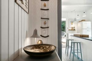 a kitchen with a large bowl on a table at Cozy Summerhouse On Bornholm in Vester Sømarken +32 photos