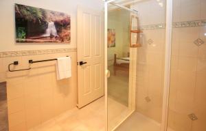 a bathroom with a shower with a glass door at Mountain Thyme in Bright +27 photos