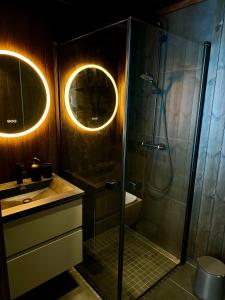 a bathroom with a shower and a sink at Modern Apartment Overlooking Gudbrandsdalen in Øyer +26 photos