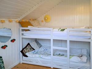 a bedroom with two bunk beds in a room at Nature Retreat By Jægerspris Beach in Jægerspris