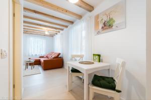 a living room with a white table and chairs at Red Fountain Studio in Braşov