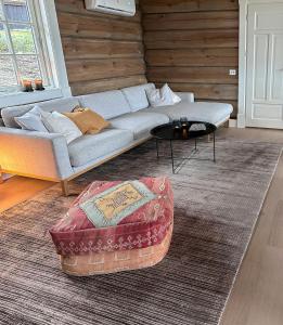 a living room with a couch and a table at Spectacular Cabin With View In Jotunheimen in Eidsbugarden