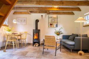 a living room with a couch and a wood stove at Oasis Of Peace Near The Lake in Langen Jarchow