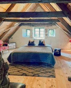 a bedroom with a large bed in a attic at 18Th-Century Limestone House In Hablingbo in Havdhem +30 photos