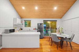 a kitchen and dining room with a table and chairs at Cozy 2BR Cottage Near Beach & Village Shops in Balnarring