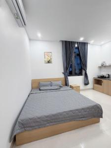 a bedroom with a large bed in a room at Nami House in Da Nang