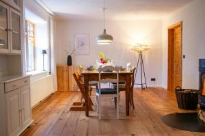 a kitchen and dining room with a table and chairs at Idyllic Country House Between Hamburg And Berlin in Langen Jarchow +9 photos