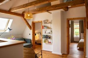 a living room with a couch and a bedroom at Idyllic Country House Between Hamburg And Berlin in Langen Jarchow