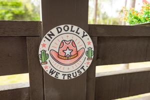 a sign on a wooden fence with the new dolilo we trust at Little Dolly (In The Pines at KY Lake) 105 Pine Grove Lane, Dover, TN 37058 in Dover +56 photos