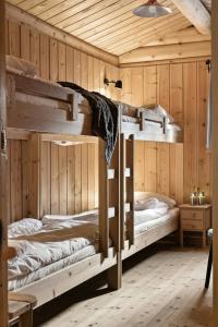two bunk beds in a room with wooden walls at Cabin With Panoramic Views Over Trysil in Trysil