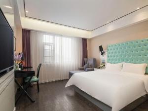 Postel nebo postele na pokoji v ubytování Xana Lite Nanchong Pengan Wuxing Garden Branch + 175 fotografií