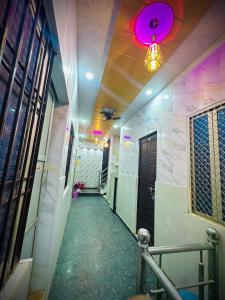 a corridor of a hallway with a pink light at Mahadev Residency in Varanasi