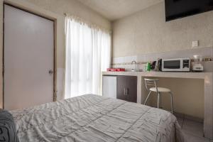 Kuchyň nebo kuchyňský kout v ubytování Hotel Bugambilias Poliforum