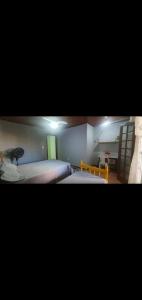 a room with two beds and a room with a desk at Suites Praia Forte Dunas in Cabo Frio