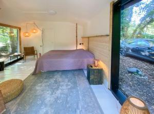 a bedroom in a house with a car outside at House In Skæring Near City And Nature in Egå