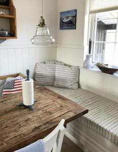 a table in a room with a couch at Beach-Close Wooden Summer House In Tversted in Tversted