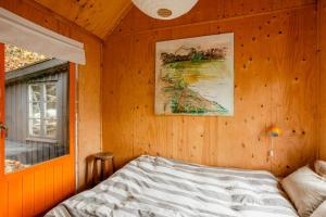 a bedroom with a bed and a picture on the wall at Swedish Quarry Guesthouse in Lönsboda