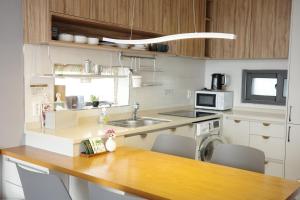 a kitchen with a wooden counter top with a sink at Aewol Bada 24 in Jeju