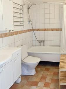 a bathroom with a toilet and a tub and a sink at Charming Villa From 1918 With Sunny Deck in Stockholm +31 photos