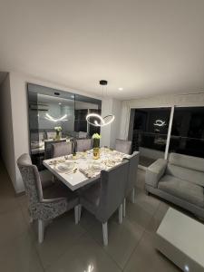 a dining room with a table and chairs and a couch at 4BRR Apto Luxury Palmetto 403 in Valledupar
