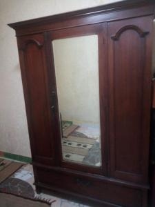 a wooden cabinet with a mirror in a room at Affordable downtown studio steps to sea free wifi in Alexandria