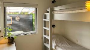 a bedroom with a bunk bed next to a window at Family Home By Scenic Coast In North Zealand in Vejby