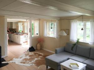 a living room with a couch and a table at Charming Country House Near Holten Beach in Nysted +14 photos