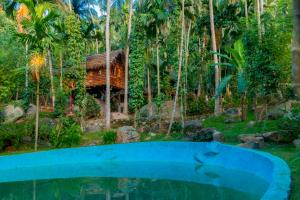 a tree house in the middle of a forest at Wooden Eco Cottage Couple Cabana in Katiyawa
