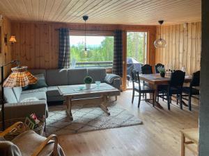 a living room with a couch and a table at Enjoy Traditional, Norwegian Cabin Coziness in Traut