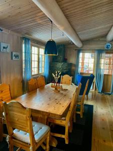 a dining room with a wooden table and chairs at Family Fun Cabin In Engerdals Heart in Nymoen