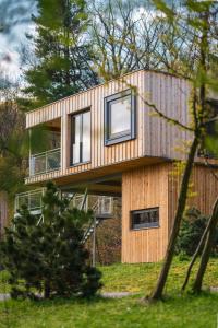 a house with two windows on the side of it at Treetop Loft In Harz National Park in Ilsenburg