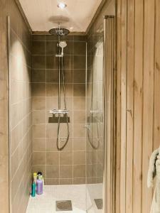 a shower with a glass door in a bathroom at Modern Cabin With Breathtaking View At Norefjell in Eggedal