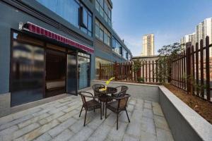 a patio with a table and chairs on a balcony at Atour Hotel Huainan Railway Station Commercial and Cultural Square in Huainan