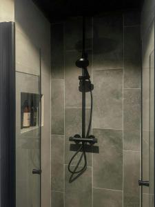 a shower in a bathroom with a glass door at Idyllic Cabin With Panoramic Mountain Views in Nerskogen