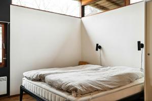 a bed in a white room with a window at Family Time At Sea Air Nature By Ebeltoft Bay in Ebeltoft