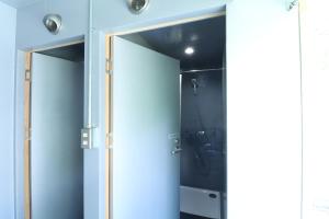 a bathroom with an open door and a shower at 南阿蘇 StayHappy in Minami Aso +41 photos