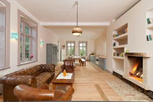 a living room with a couch and a fireplace at Spacious Apartment With Terrace And Garden View in Walow